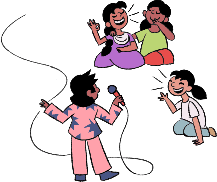 A girl and her friends are happily seated around a stand-up comedian who is holding a microphone and telling them jokes.